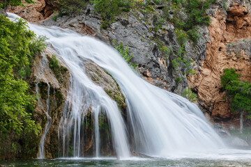 Beautiful cascade waterfall captured with a long exposure with natural pool water. Scenic landscape, ideal for backgrounds and travel concepts. Turner Falls Park, Oklahoma