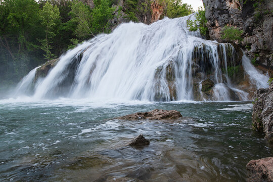 Beautiful cascade waterfall captured with a long exposure with natural pool water. Scenic landscape, ideal for backgrounds and travel concepts. Turner Falls Park, Oklahoma