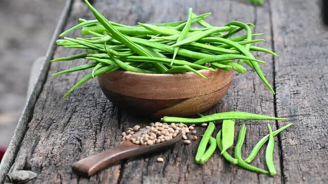 Cluster beans or gawar phali (guar) seed on wooden background, Cyamopsis tetragonoloba