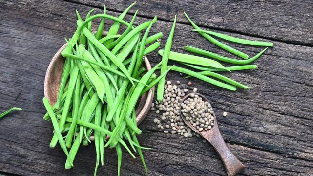 Cluster beans or gawar phali (guar) seed on wooden background, Cyamopsis tetragonoloba