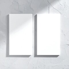 Two blank business cards on textured wall