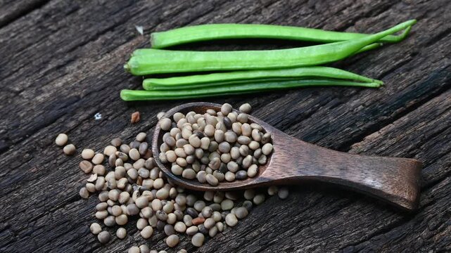 Cluster beans or gawar phali (guar) seed on wooden background, Cyamopsis tetragonoloba
