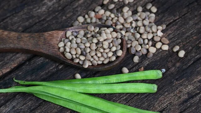Cluster beans or gawar phali (guar) seed on wooden background, Cyamopsis tetragonoloba