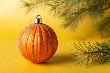Holiday Ornament and Pine: a festive close-up captures a stunning orange ornament, radiating warmth, enhanced by a pine branch. It's a scene, perfect to evoke festive spirit.