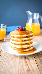 Stacked pancakes with syrup and fruit