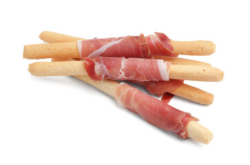 Delicious grissini sticks with prosciutto isolated on white
