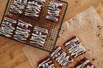 Halloween chocolate mummy cookies treats, spooky and funny dessert, top view