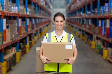 Sealed cardboard boxes are resting on metal shelving racks in warehouse aisle, with pallets below