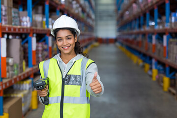 Handheld barcode scanner sitting on metal shelves in warehouse aisle, showcasing inventory