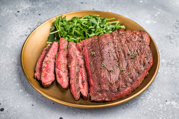A delectable grilled top sirloin steak served with salad, ready to satisfy your cravings for...