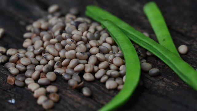 Cluster beans or gawar phali (guar) seed on wooden background, Cyamopsis tetragonoloba