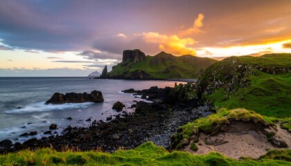 Dramatic sunset over coastal cliffs and rocky shore