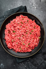 Lamb Mutton ground mince raw meat, forcemeat on a black plate, top view.