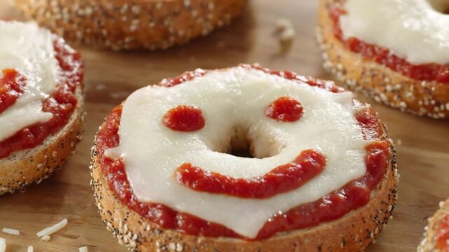 Cheerful Bagel Pizza with Melted Cheese and Tomato Sauce Smiling Face.