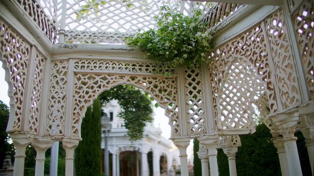 Ornate white gazebo with intricate latticework and arches