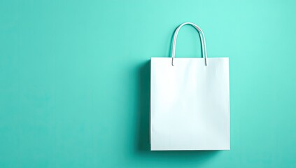 Blank white paper shopping bag against a teal background (2)