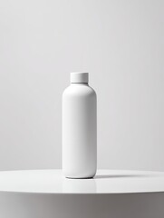 A plain white bottle stands on a white pedestal against a bright white backdrop