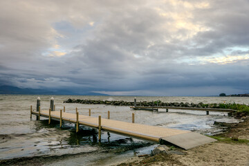 A dock is on a pier in front of a body of water