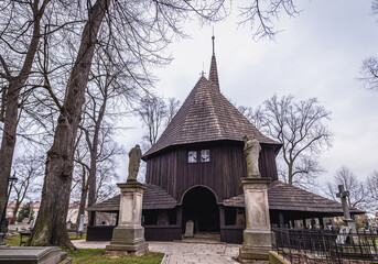 Fototapeta premium Rear view of historic wooden Church of Virgin Mary on a cemetery in Broumov city, Czech Republic