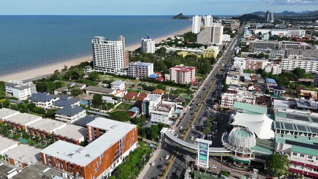 Aerial panoramic view of Hua Hin city with coastline, beach, and modern buildings on a sunny day