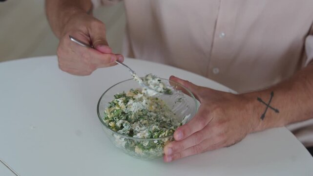 A chef professionally prepares a fresh vegetable salad, chopping potatoes, eggs, and greens. Dynamic cooking process showcasing culinary skills and healthy food preparation