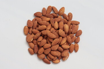 Almonds lay on white background in round shape
