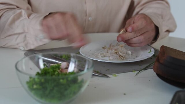 A chef professionally prepares a fresh vegetable salad, chopping potatoes, eggs, and greens. Dynamic cooking process showcasing culinary skills and healthy food preparation
