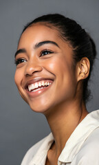 Close-up of young woman smling against grey backgroud, successful multiethnic irl