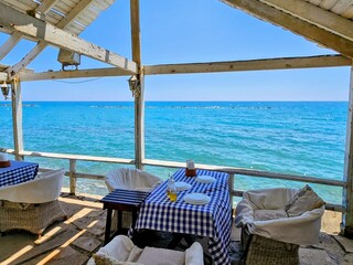 Seaside dining with ocean view and blue checked tablecloth