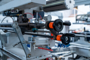 Industrial machine with metal and plastic rollers, engineering closeup
