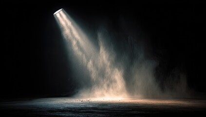 Spotlight illuminates dust on a dark stage