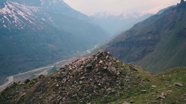 Landscape shot of river Chandra flowing between the Himalayan mountain valley as seen near Sissu village in Lahaul and Spiti district, Himachal Pradesh, India. Scenic view of river in Himalayas.