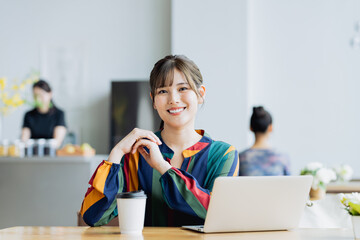 カフェで仕事をする若い女性