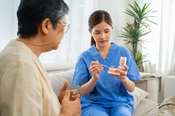 woman in  blue scrubs is holding  toothbrush
