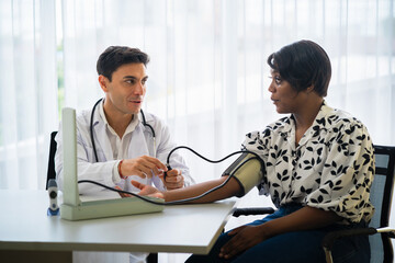 doctor is checking  woman's blood pressure
