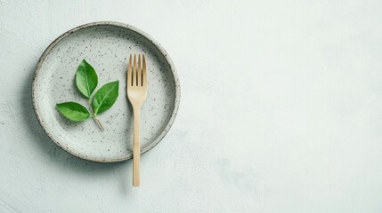 Gray plate with wooden fork and basil