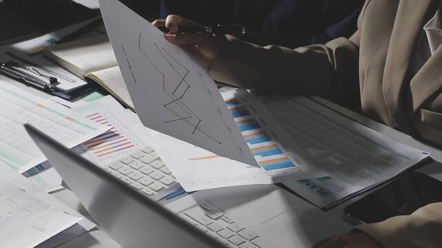 Teamwork with business people analysis cost graph on desk at meeting room.
