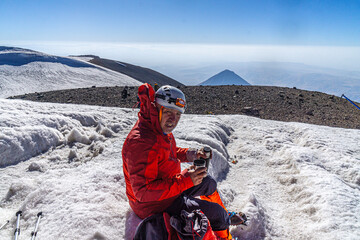 The mountaineer is at the summit of Mount Ararat, with an elevation of 5,137 m (16,854 ft), also...