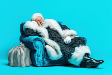 sleeping santa with silver gift bag on blue background