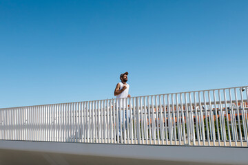 Man jogging outdoors on a bridge in Lisbon during a sunny morning