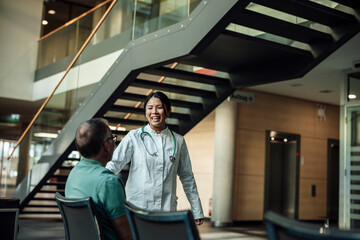Doctor consulting patient in clinic waiting area offering support