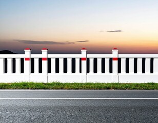 Roadside white fence at sunset