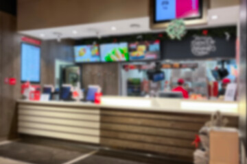 Busy fast food counter at a popular dining spot featuring colorful menus and staff ready to serve customers blurred.