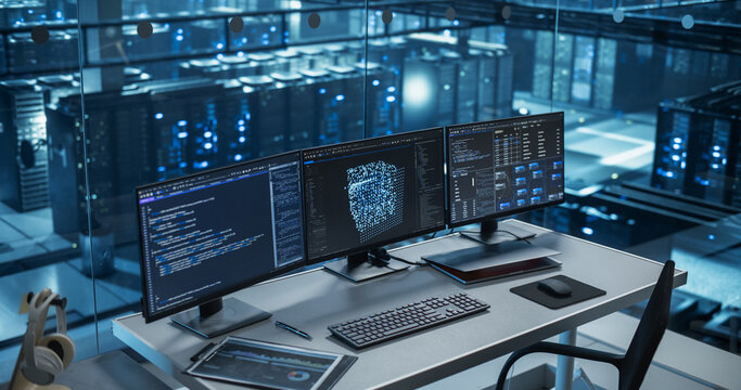 Modern Office Desk in a Data Center, Equipped with Multiple Monitors Displaying Complex AI Code and Data Visualizations, Ready for a Team of Developers to Dive In. Footage Without People