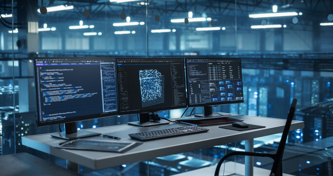 Modern Office Desk in a Data Center, Equipped with Multiple Monitors Displaying Complex AI Code and Data Visualizations, Ready for a Team of Developers to Dive In. Footage Without People