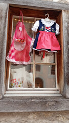 traditional Swiss children's clothing hanging on a wooden window