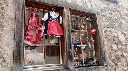 traditional Swiss children's clothing hanging on a wooden window