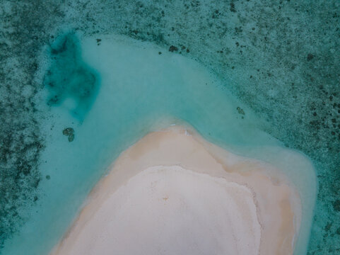 Maldives, Maldives - 31 May 2019: Aerial view of a pristine sandbank embraced by the turquoise waters of the Indian Ocean, creating a mesmerizing contrast of textures and hues..