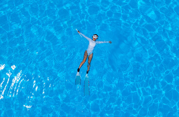 Tropical of Summer vacation concept with Relax lifestyle of young woman lying on the poolside -Summer travel concept