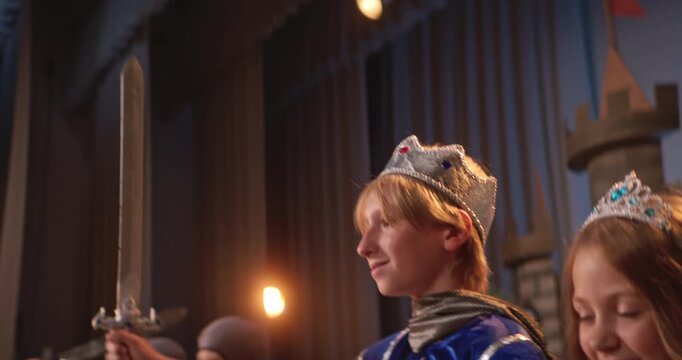 School play depicting medieval times with children in costumes on stage